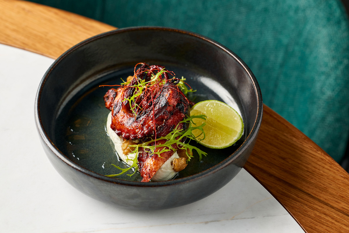 Charred Fremantle octopus with smoked labneh, chickpeas, chilli, lime. Cooked on the Parrilla Charcoal Grill.